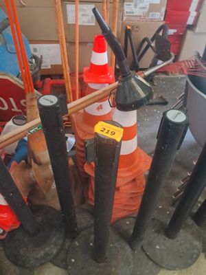 a lot of traffic cones and poles in a room