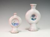 two vases sitting next to each other on a table