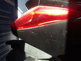 a close up of a motorcycle with a red tail light
