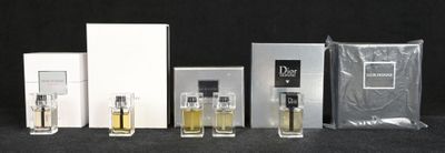 Plusieurs flacons de parfum sont alignés sur une surface noire
