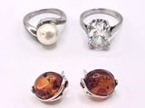 trois bagues ornées d'une perle et une bague ornée d'une pierre