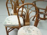 four chairs and a table in a room with a white floor
