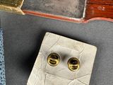 a knife, a hammer, and a pair of earrings on a table
