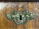 a keyhole on a wooden door with a bunch of flowers on it
