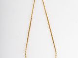 a gold necklace with a chain on a white background