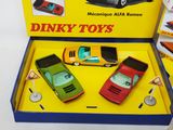three toy cars in a box on a table