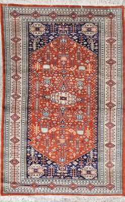 an orange and blue rug with a medallion design