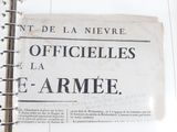 an old french newspaper on a desk with a pen