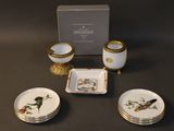 three plates and a bowl on a table with a box