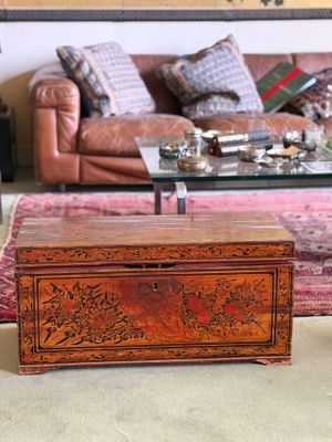 a wooden box sitting on the floor in a living room
