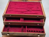a wooden box that has a bunch of tools inside of it