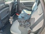 a picture of the inside of a car with a bag in the back seat