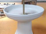 a white sink sitting on top of a yellow floor