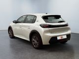 the rear end of a white car parked in a room