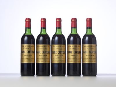 four bottles of wine are lined up on a table