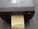 a printer with a roll of yellow paper on top of it