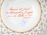 a plate with writing on it with a gold border around it