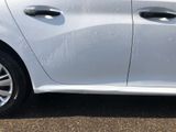 a white car that is parked on the side of the road