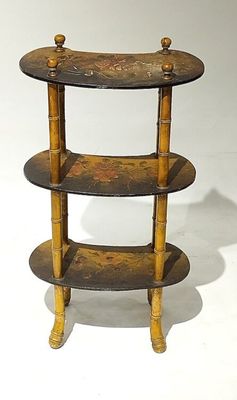a small wooden shelf with three shelves on it