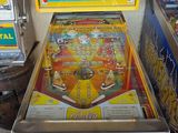 an image of a pinball machine sitting on top of a wooden table