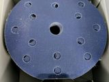 a blue disc in a box with holes on it
