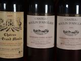 several bottles of wine are lined up on a shelf