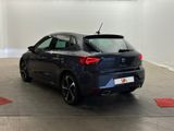 the rear end of a blue car parked in a garage