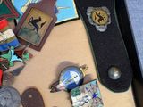 a suitcase filled with assorted badges and other items