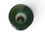 a green vase with a hole in it on a white surface