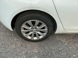 a white car that is parked on the side of the road