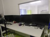 an image of a desk with three computer monitors on it