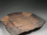 an image of a wooden plate with a square design on it