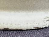 a close up of a white vase on a table