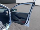 a white car with its door open in a parking lot
