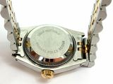 a close up of a watch on a white surface