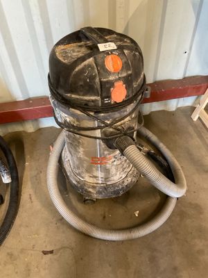 a vacuum and a hose in a room