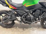a green and yellow motorcycle parked in a parking lot