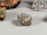 several different types of rocks and crystals are displayed on a white surface