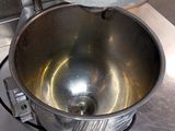 a large metal bowl with a whisk inside of it