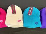 four pairs of beanies are lined up on a black surface