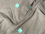 a close up of a pair of khaki pants with green tags on them
