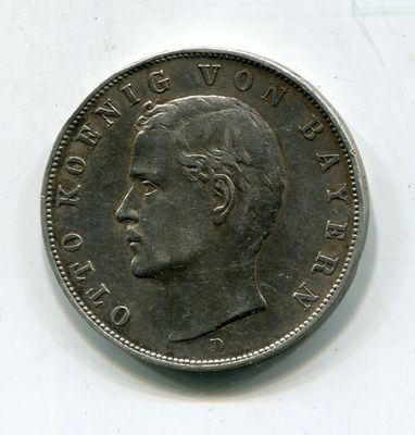 Gros plan sur une pièce de monnaie portant le visage d'un homme