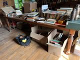 a table with a lot of books on it in a room