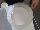 a person that is holding a plate on a table