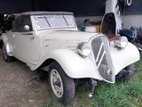 an old car that is parked in a garage