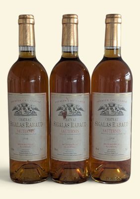 three bottles of wine sitting next to each other on a white surface
