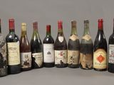 several bottles of wine are lined up in a row on a table