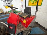 a red machine that is parked in a garage