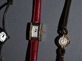 several different types of watches are displayed on a black surface