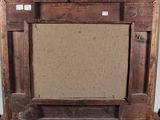 an old wooden frame with a picture hanging on the wall